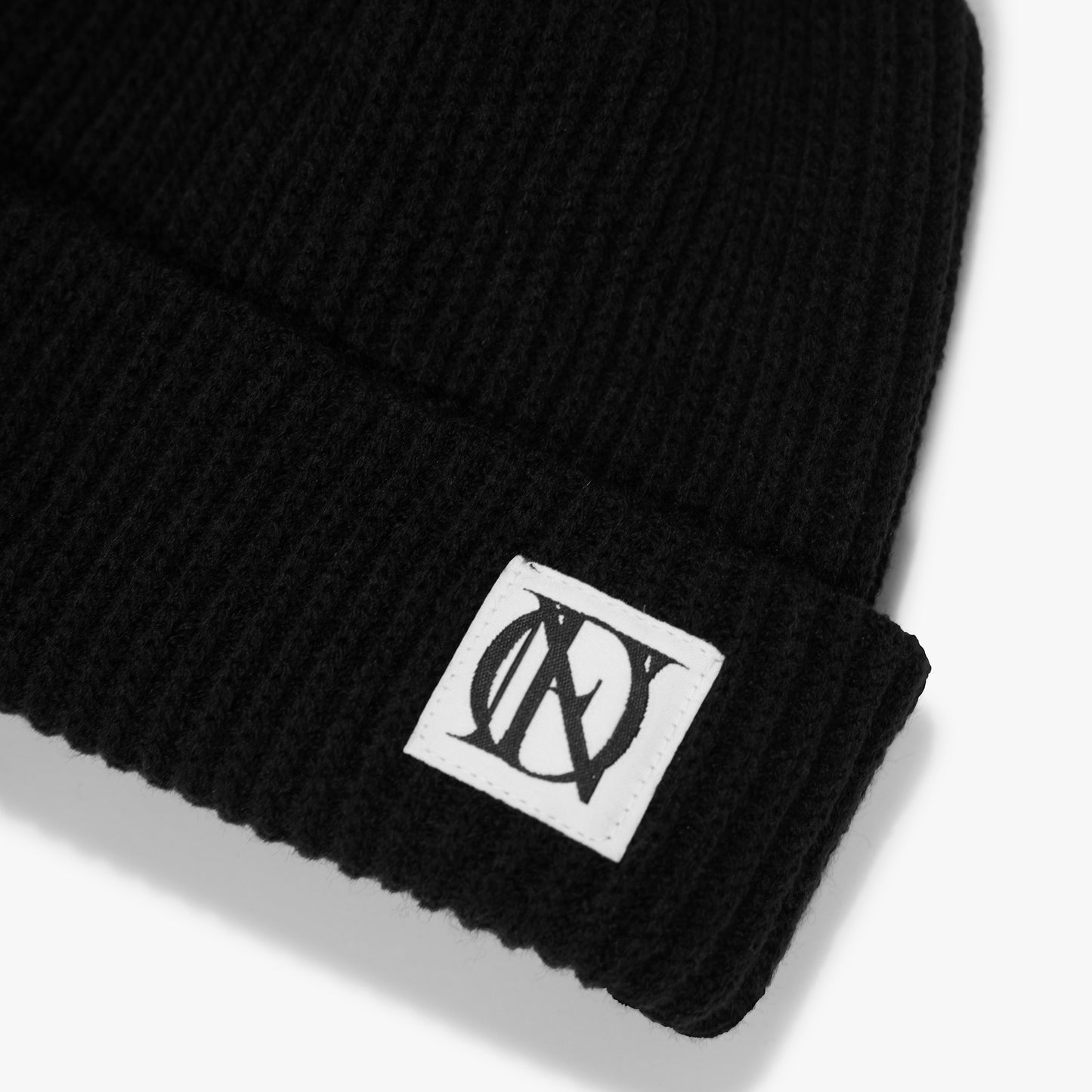Close up shot of the OG 'OFFEND' logo on black beanie on a white background