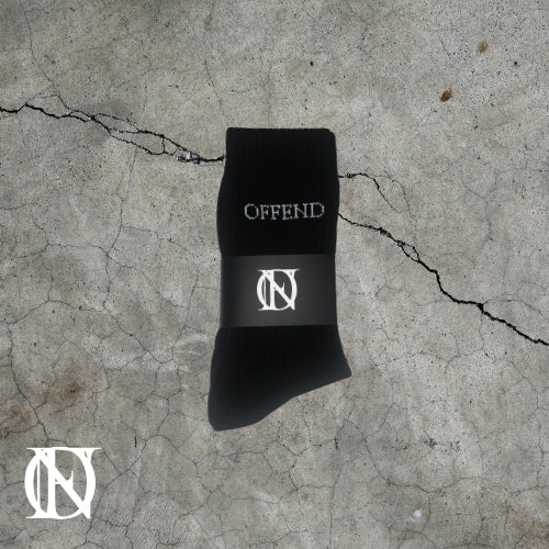 Black socks with 'OFFEND' text