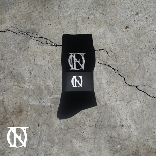 Black socks with the OFFEND logo