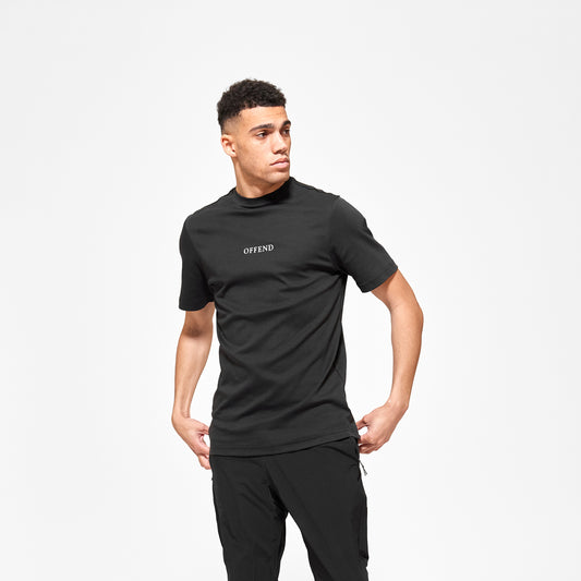 Model wearing 'OFFEND' black T shot from the front with 'OFFEND' text across the centre of chest 