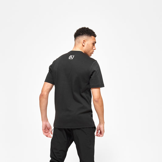 Model wearing 'OFFEND' black T shot from the back with 'OFFEND' logo at the nape of the neck