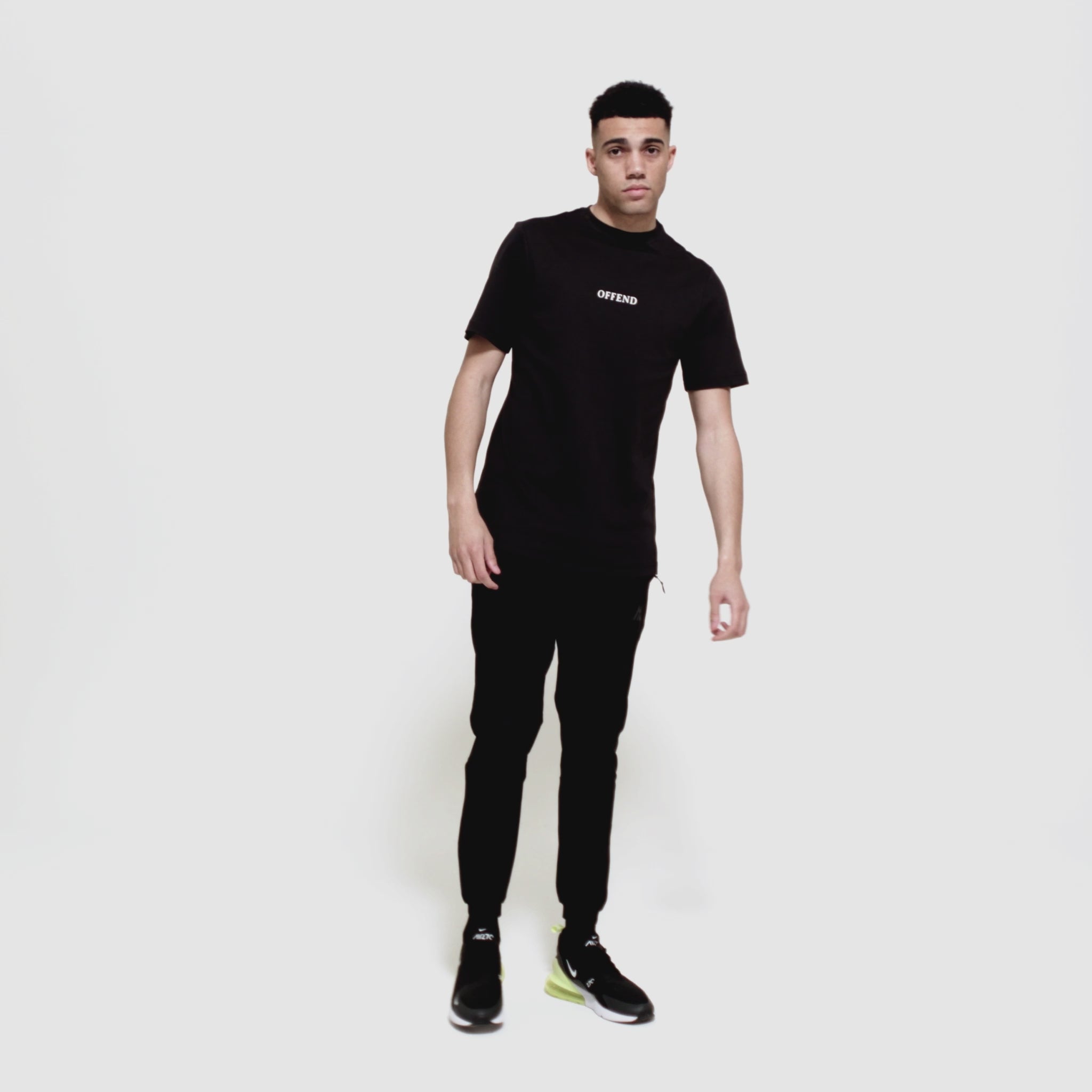 Model wearing 0G 'OFFEND' black T-Shirt moving around showcasing the front and back of the T-shirt as well as close up shots on a white background