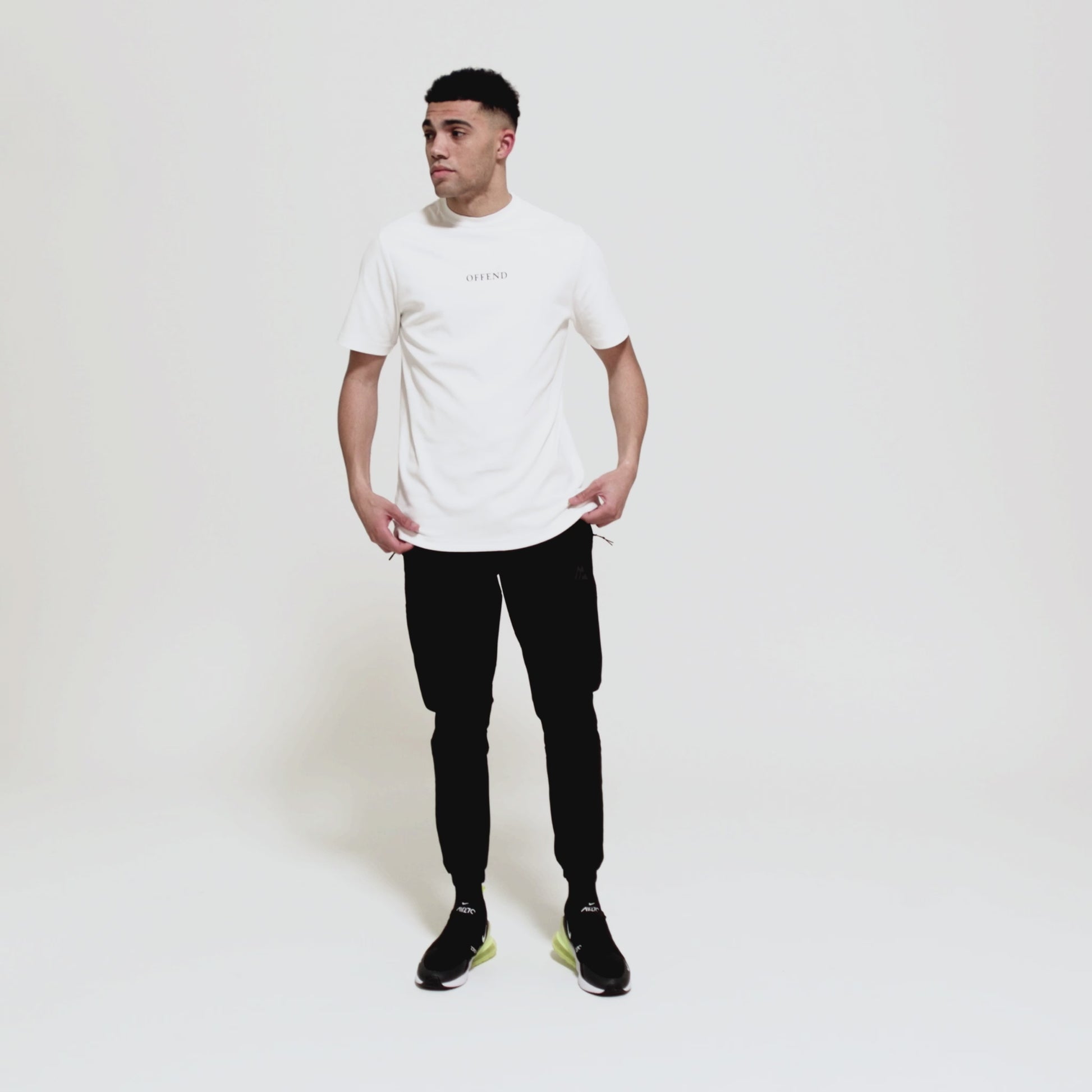 Model wearing 0G 'OFFEND' white T-Shirt moving around showcasing the front and back of the T-shirt as well as close up shots on a white background